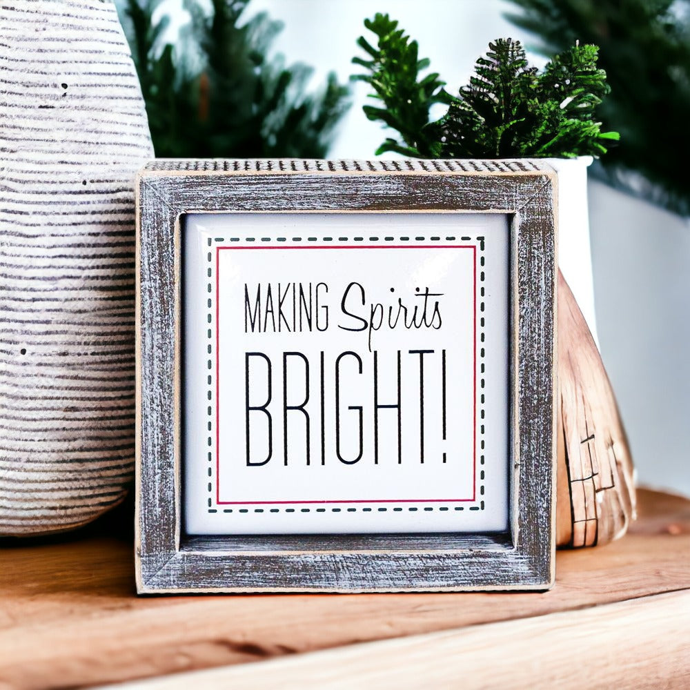 A 5-inch wooden framed sign with the text 'Making Spirits Bright' embossed in metal, featuring a festive red border.