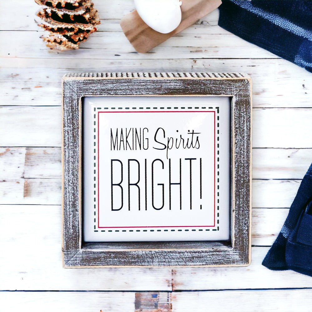 A 5-inch wooden framed sign with the text 'Making Spirits Bright' embossed in metal, featuring a festive red border.