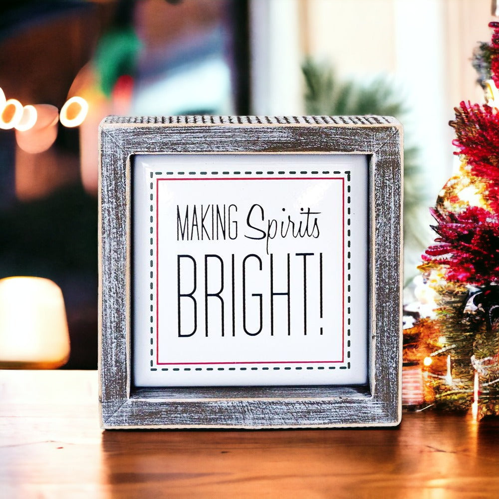 A 5-inch wooden framed sign with the text 'Making Spirits Bright' embossed in metal, featuring a festive red border.