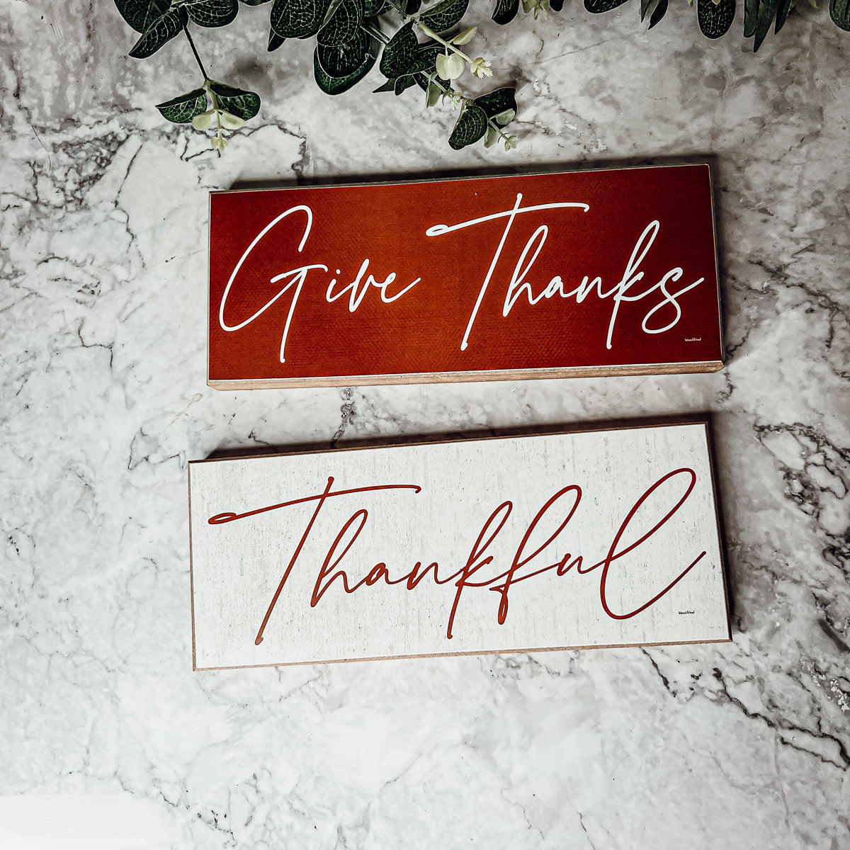 Two rustic wooden signs with 'Give Thanks' and 'Thankful' in elegant script, perfect for home decor.