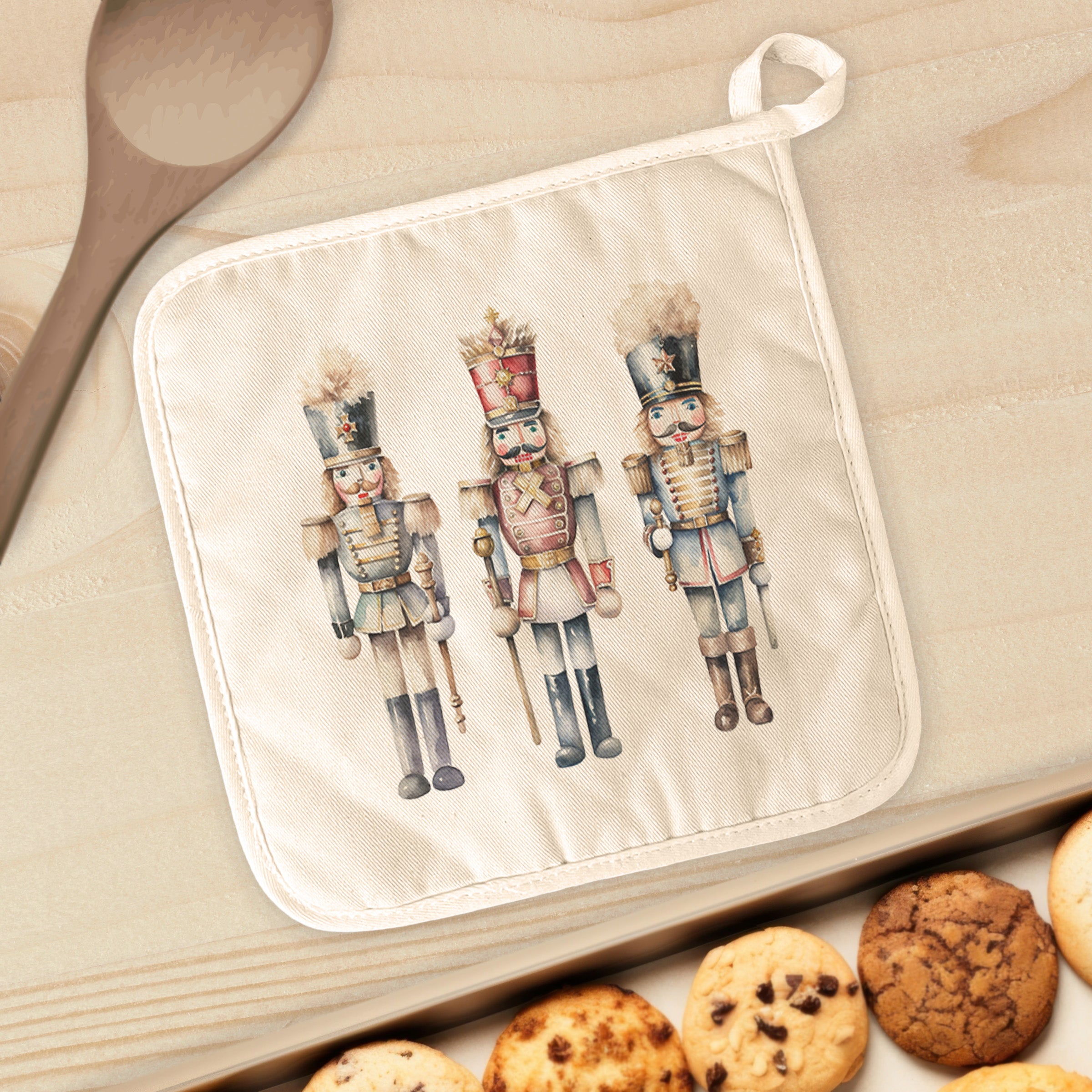 Three Nutcrackers Cotton Pot Holder featuring vibrant designs and a convenient hanging loop, perfect for protecting surfaces from hot cookware.