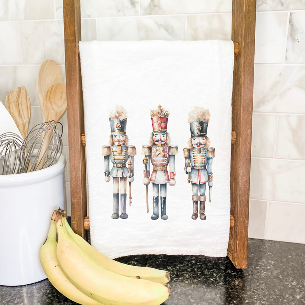 Three Nutcrackers Cotton Tea Towel featuring vibrant water-based ink design on absorbent fabric, perfect for kitchen use.