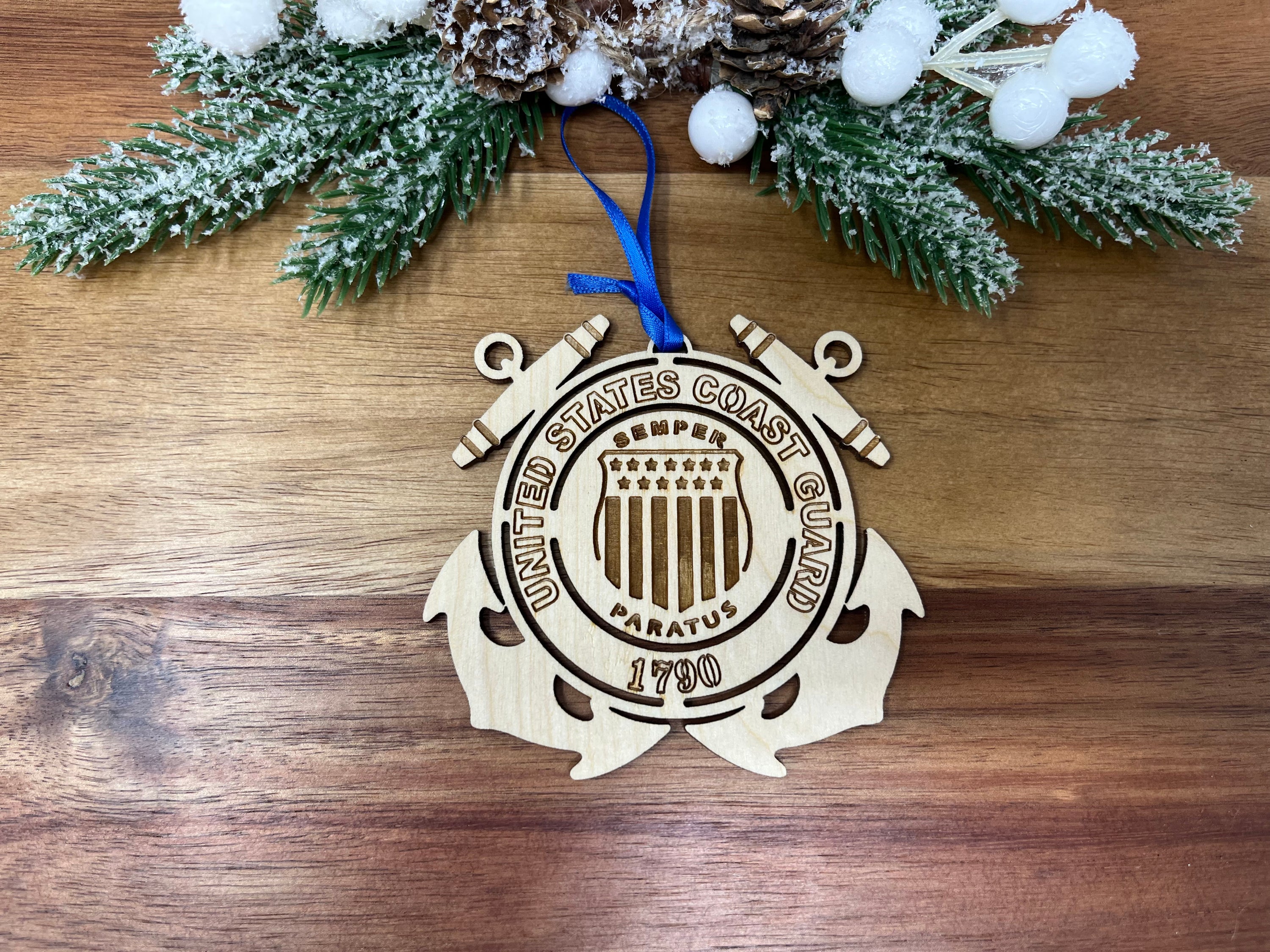 Handcrafted wooden ornament featuring the United States Coast Guard emblem, approximately 4 inches in diameter.