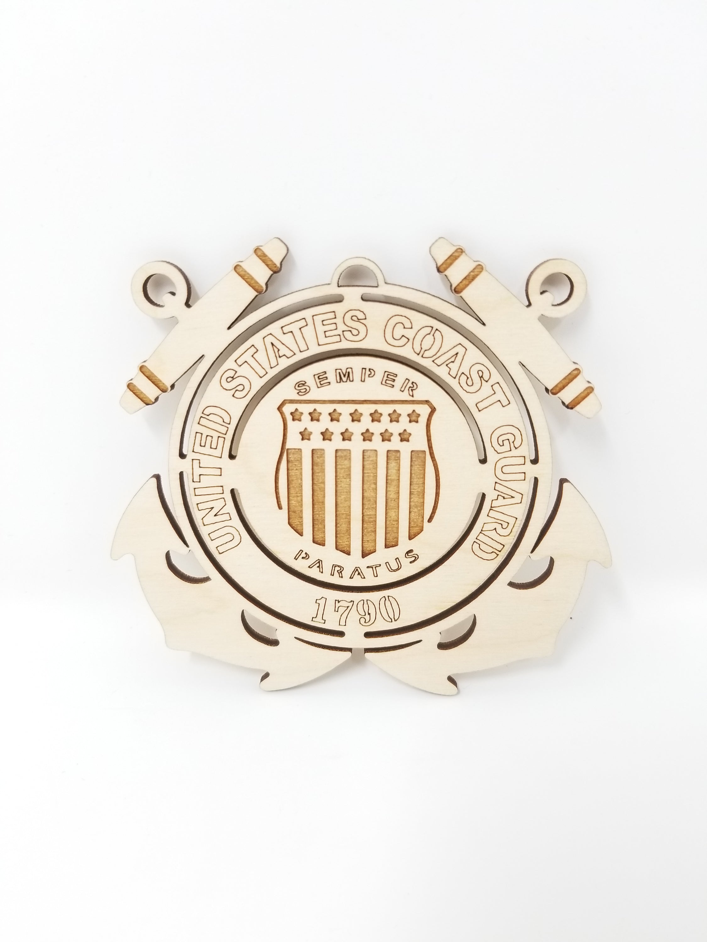 Handcrafted wooden ornament featuring the United States Coast Guard emblem, approximately 4 inches in diameter.