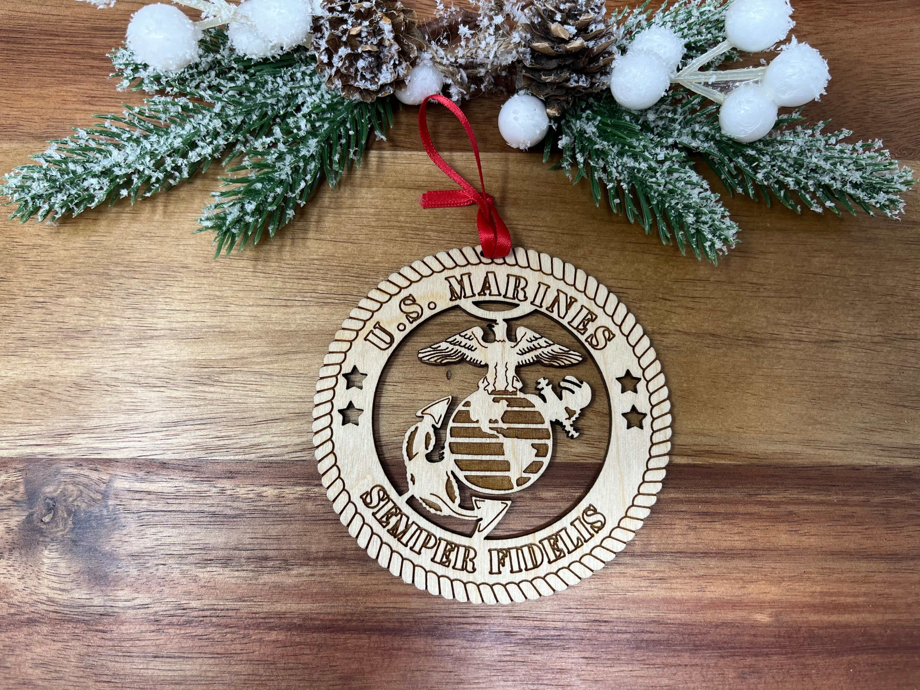 A beautifully crafted wooden ornament featuring the United States Marines emblem, measuring 4 inches in diameter, perfect for honoring military service.