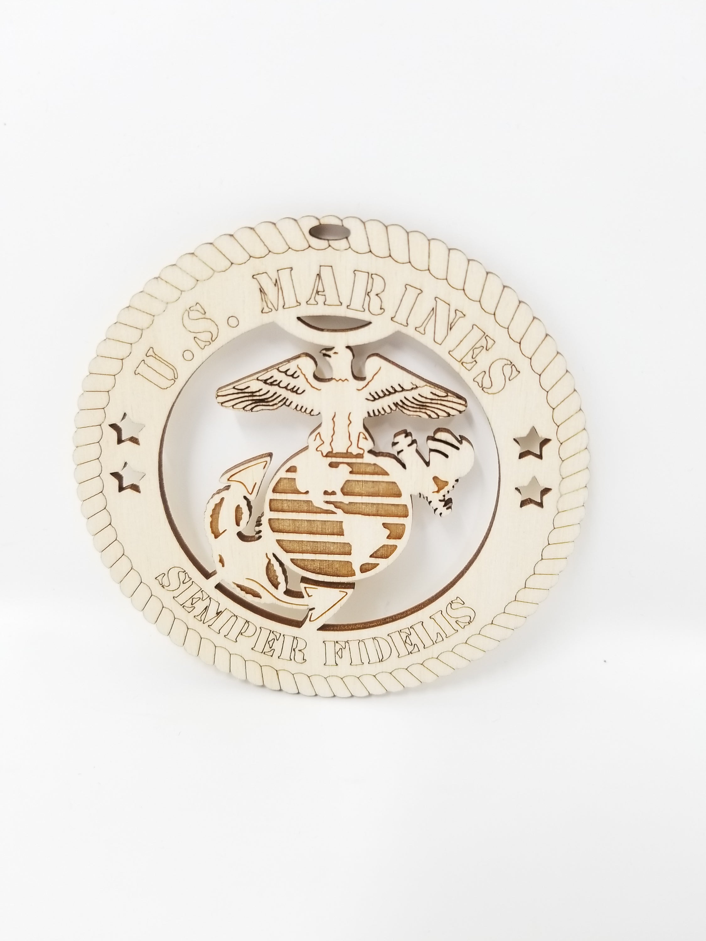 A beautifully crafted wooden ornament featuring the United States Marines emblem, measuring 4 inches in diameter, perfect for honoring military service.