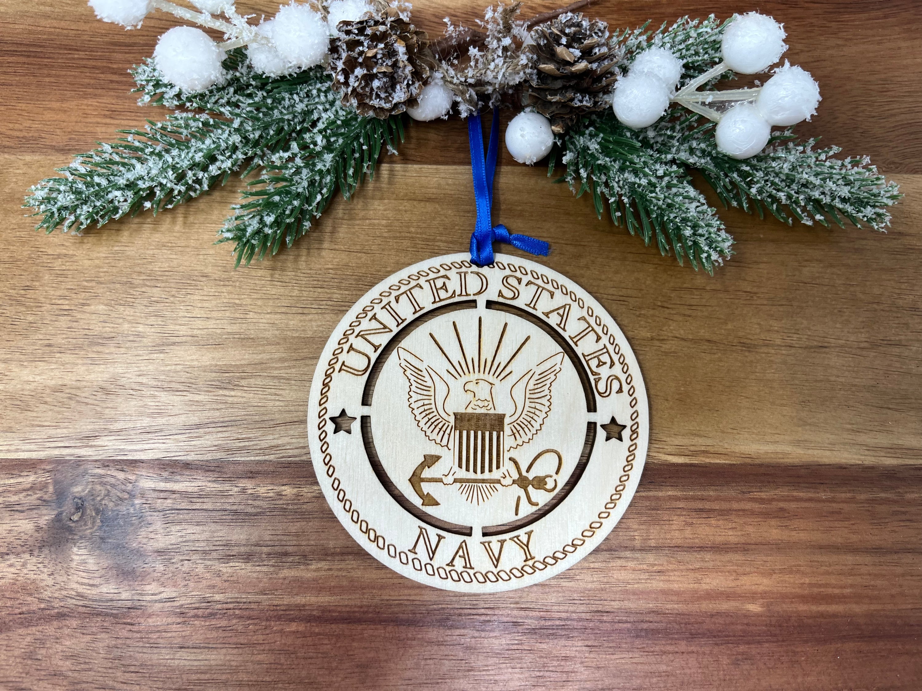 A beautifully crafted wooden ornament featuring the United States Navy emblem, approximately 4 inches in diameter.