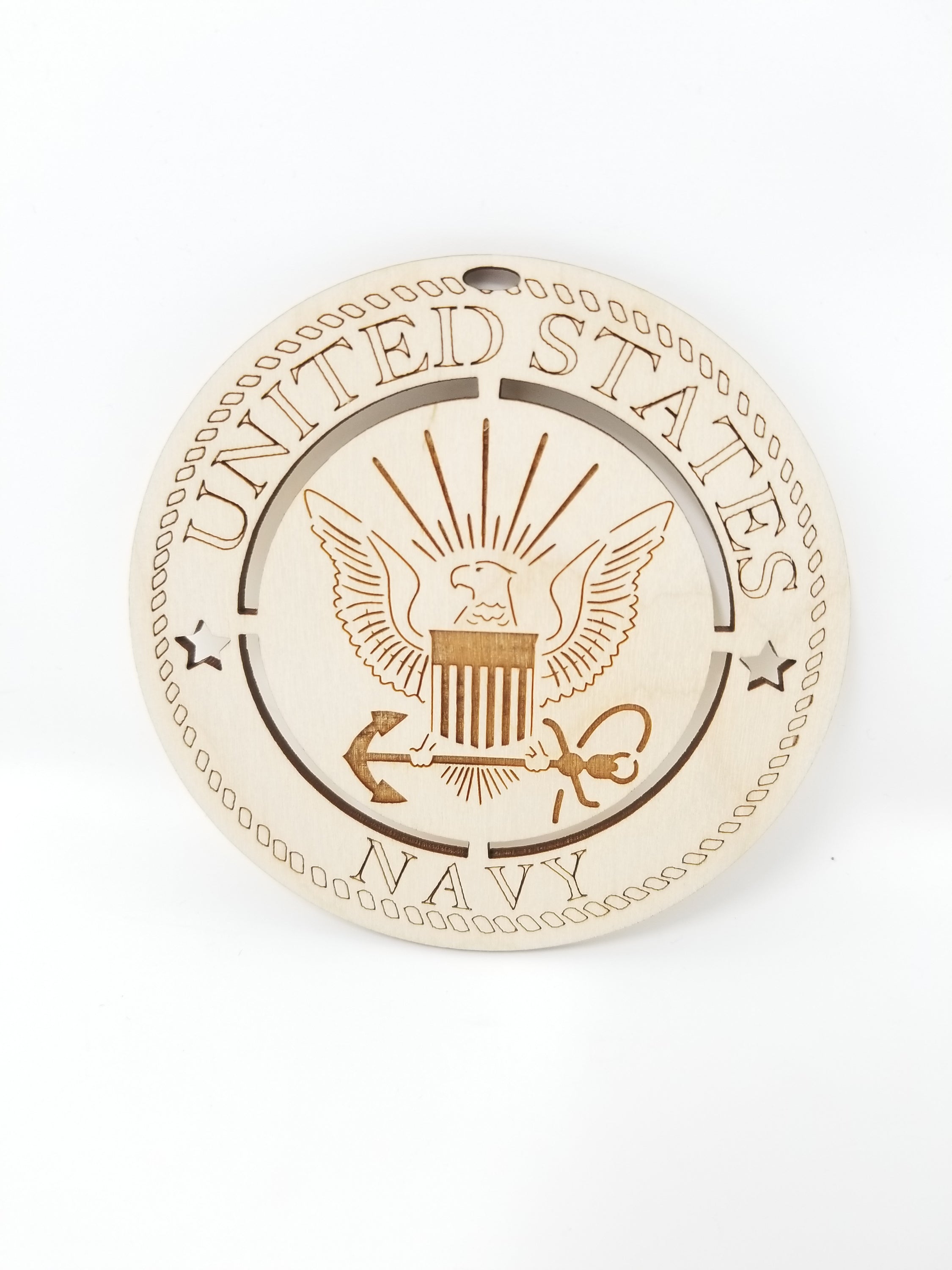 A beautifully crafted wooden ornament featuring the United States Navy emblem, approximately 4 inches in diameter.