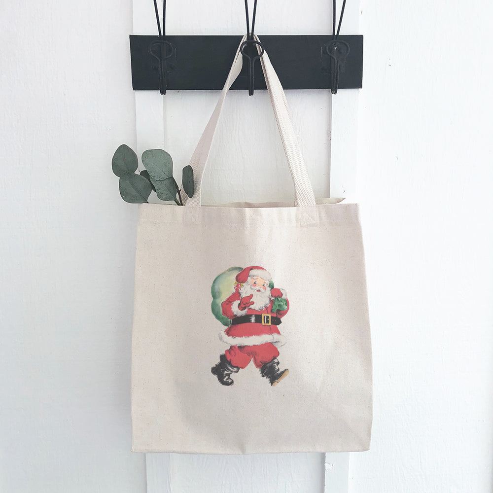 Vintage Santa Canvas Tote Bag featuring a festive Santa design with a gift sack, made from durable heavy-duty canvas.