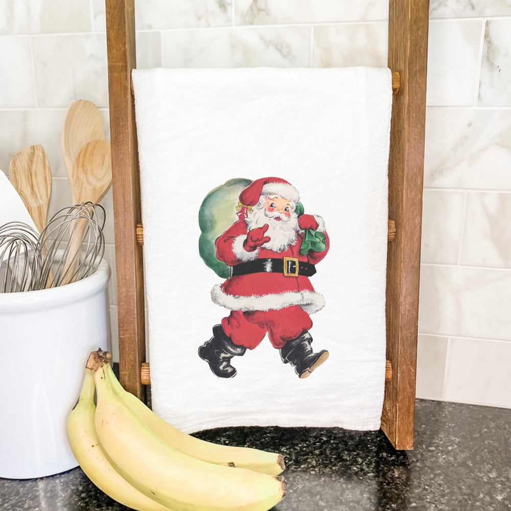 Vintage Santa Cotton Tea Towel featuring a cheerful Santa with a gift sack, designed in vibrant colors on a soft cotton fabric.