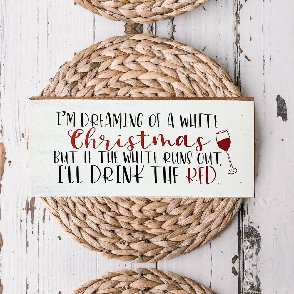 A handmade wooden sign featuring a humorous Christmas quote about wine, designed for festive decor.