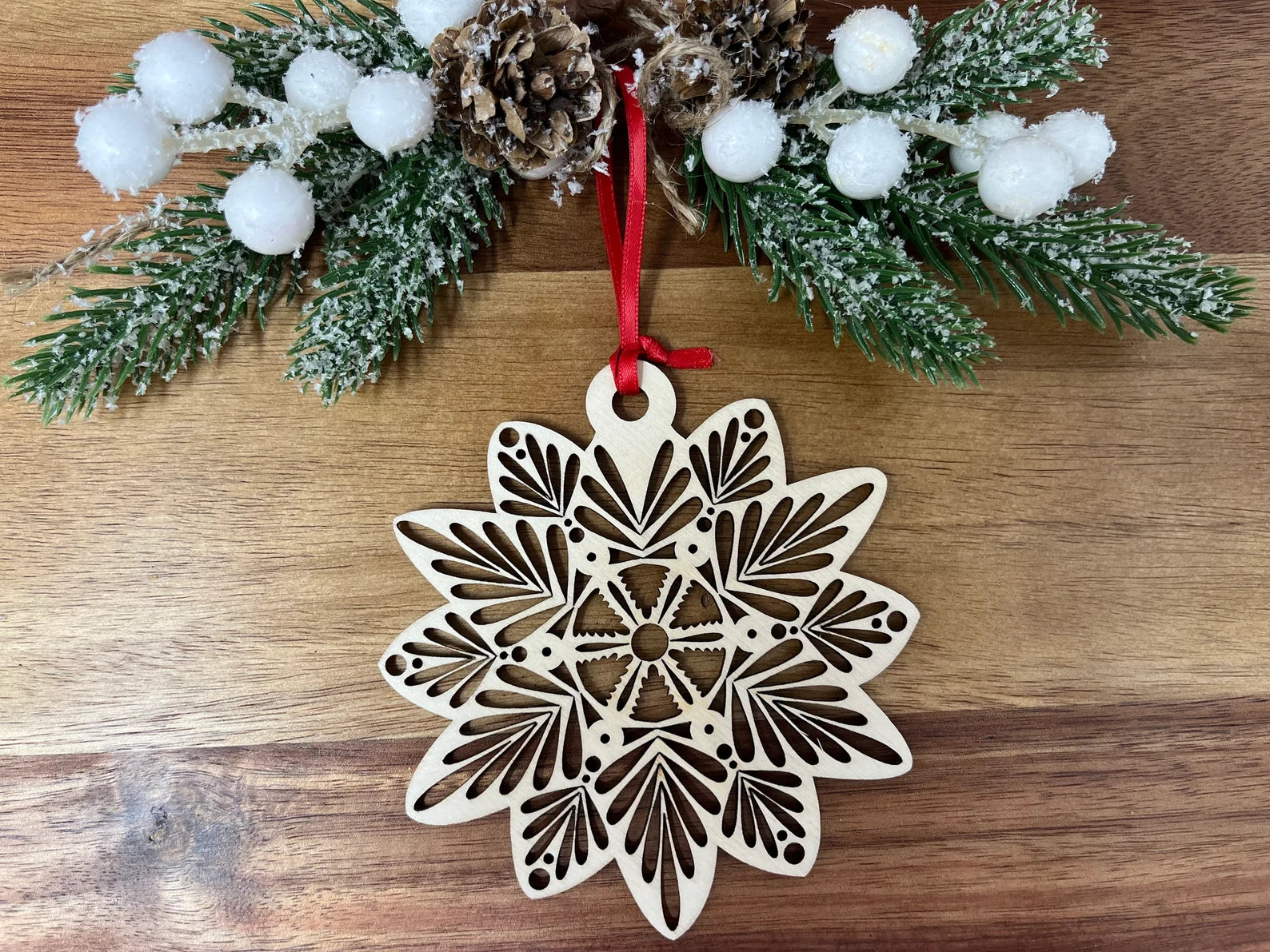 Intricate laser cut wooden snowflake ornament made from premium Baltic Birch, elegantly displayed in a jewelry box.