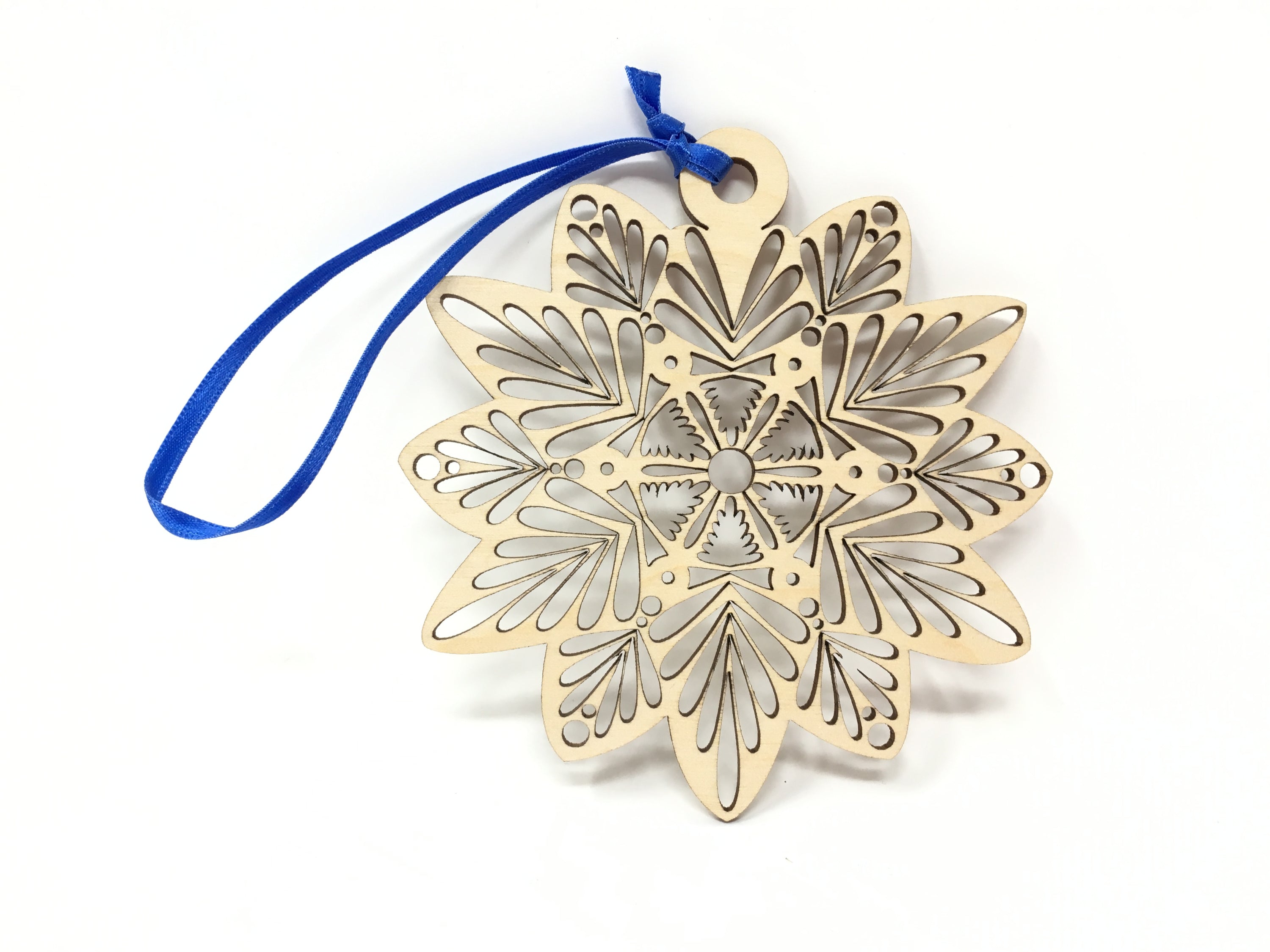 Intricate laser cut wooden snowflake ornament made from premium Baltic Birch, elegantly displayed in a jewelry box.