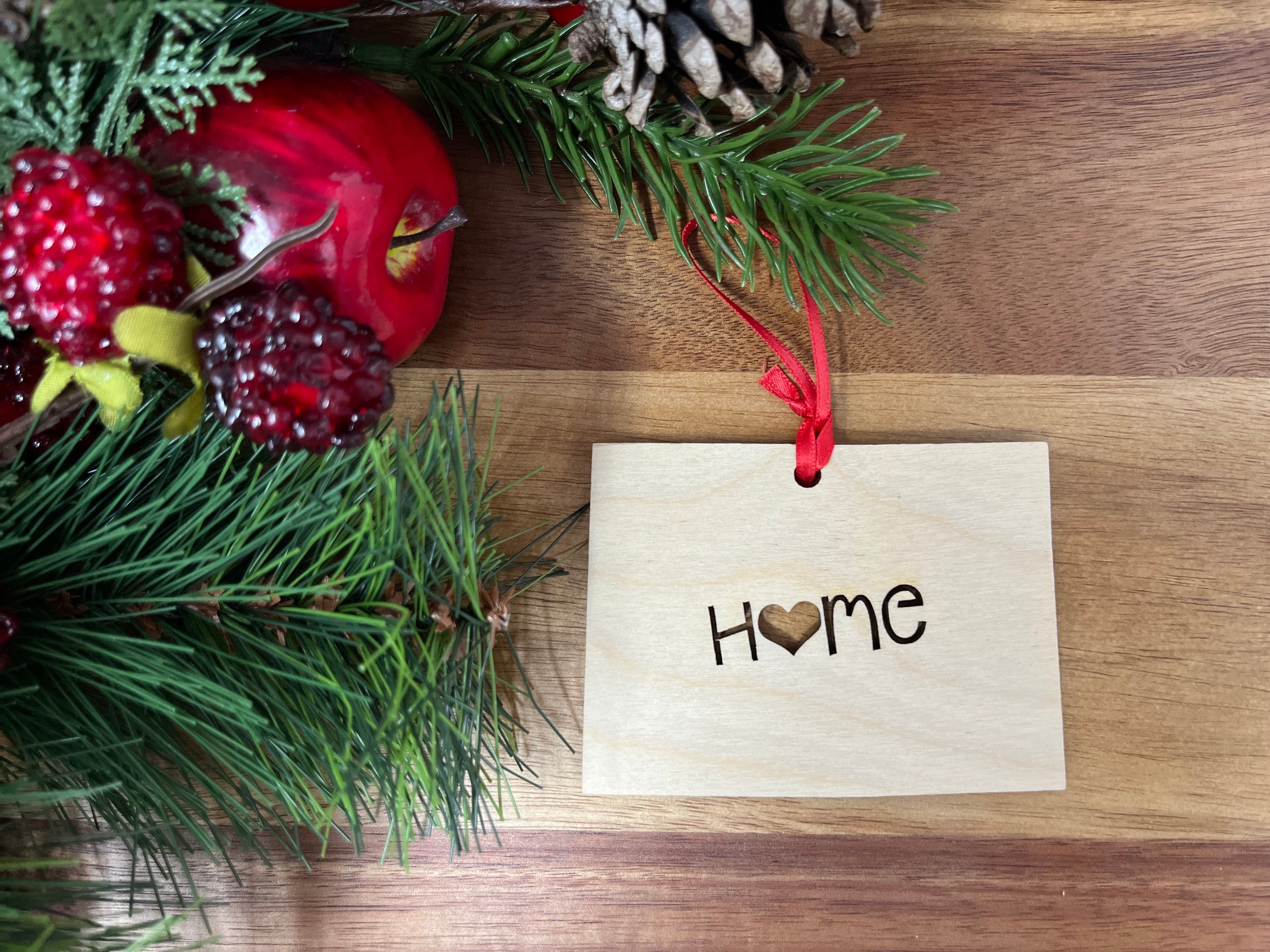 Wyoming State Wood Christmas Ornament made of Baltic Birch, featuring the word 'Home' in a rustic design.