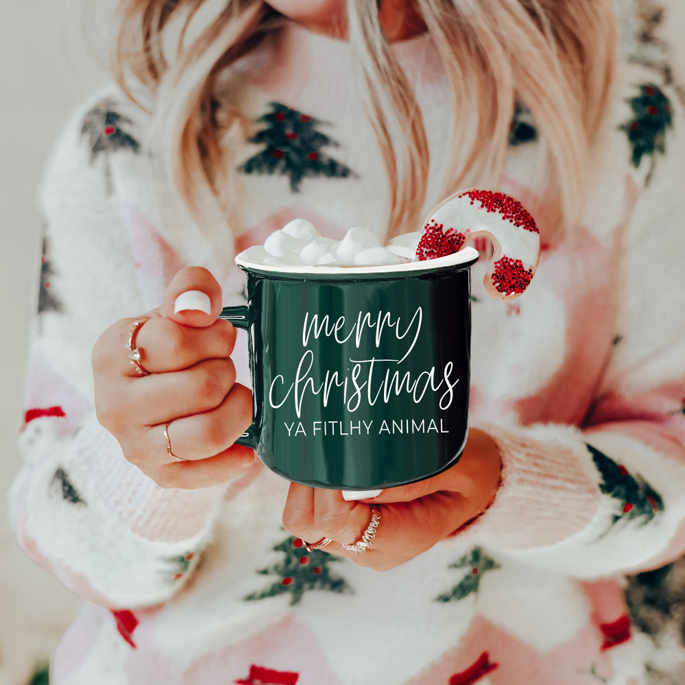 A quirky ceramic mug featuring the phrase 'Ya Filthy Animal' with the word 'Filthy' humorously misspelled as 'Fitlhy', available in red or green.