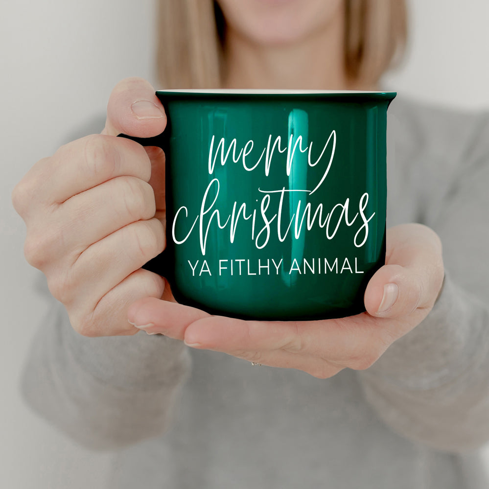 A quirky ceramic mug featuring the phrase 'Ya Filthy Animal' with the word 'Filthy' humorously misspelled as 'Fitlhy', available in red or green.