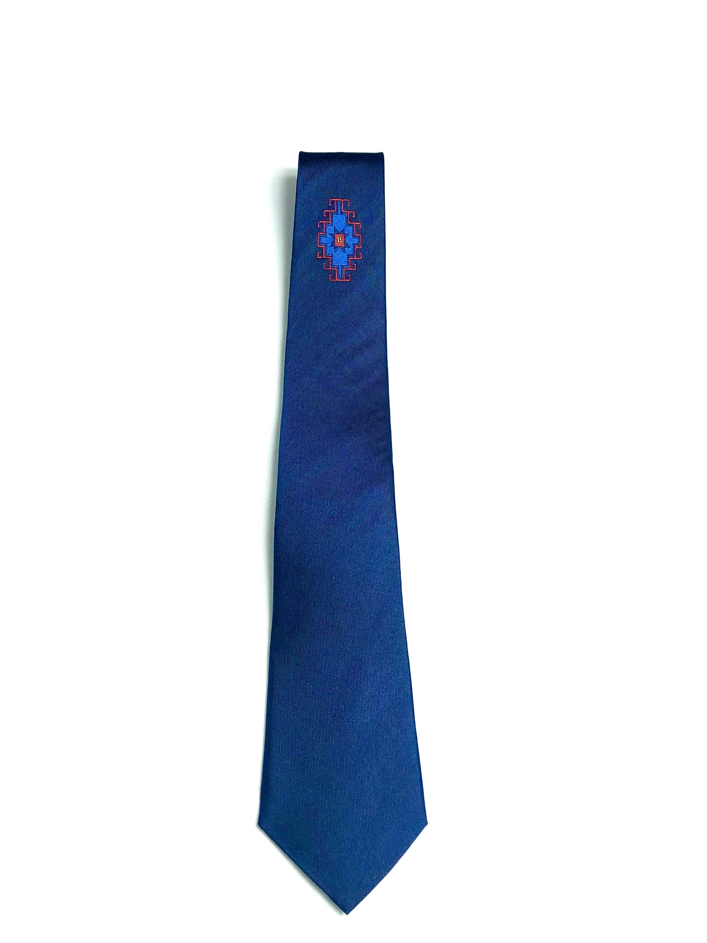 Armenian Rug underknot silk necktie featuring intricate patterns in navy, red, and blue colors, elegantly displayed.