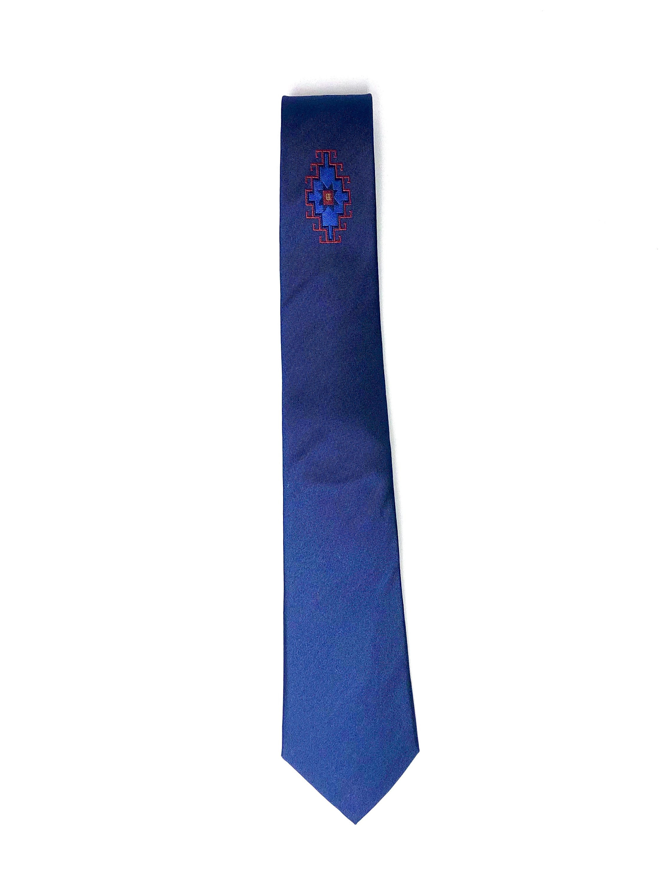 Armenian Rug underknot silk necktie featuring intricate patterns in navy, red, and blue colors, elegantly displayed.