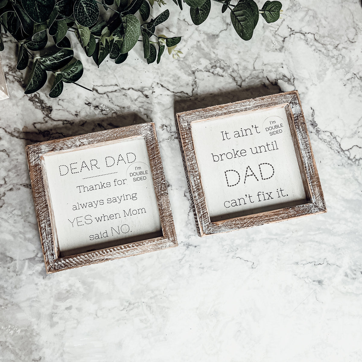 Double-sided wooden sign featuring humorous and heartfelt messages for dads, framed in rustic white wash.