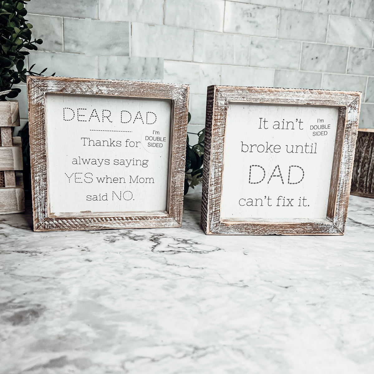 Double-sided wooden sign featuring humorous and heartfelt messages for dads, framed in rustic white wash.