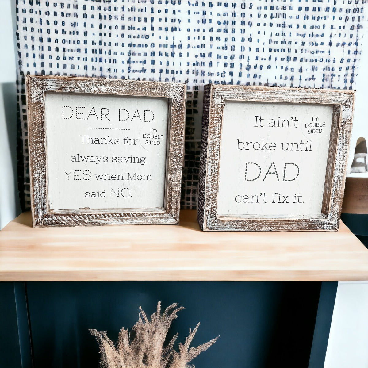 Double-sided wooden sign featuring humorous and heartfelt messages for dads, framed in rustic white wash.