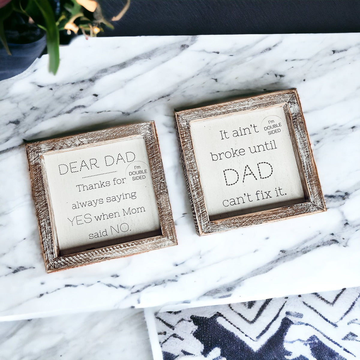 Double-sided wooden sign featuring humorous and heartfelt messages for dads, framed in rustic white wash.