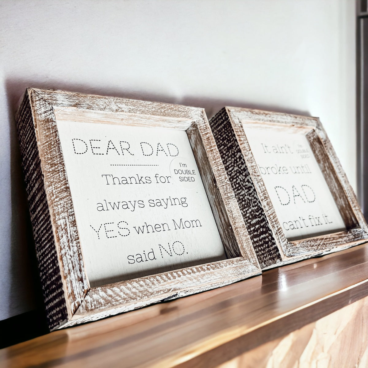 Double-sided wooden sign featuring humorous and heartfelt messages for dads, framed in rustic white wash.