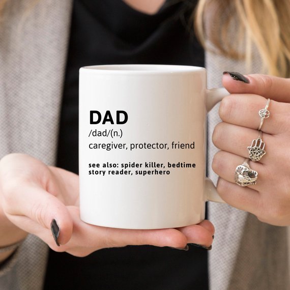 Funny coffee mug with the phrase 'DAD (n.) caregiver, protector, friend, see also: spider killer, bedtime story reader, superhero' printed on it.