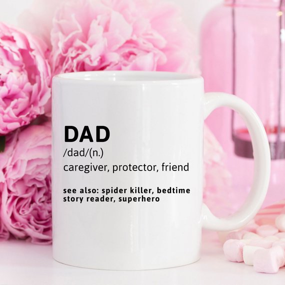 Funny coffee mug with the phrase 'DAD (n.) caregiver, protector, friend, see also: spider killer, bedtime story reader, superhero' printed on it.