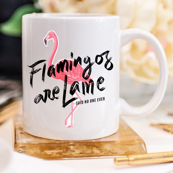 A colorful flamingo-themed coffee mug with a humorous quote, perfect for coffee lovers and gift-giving.