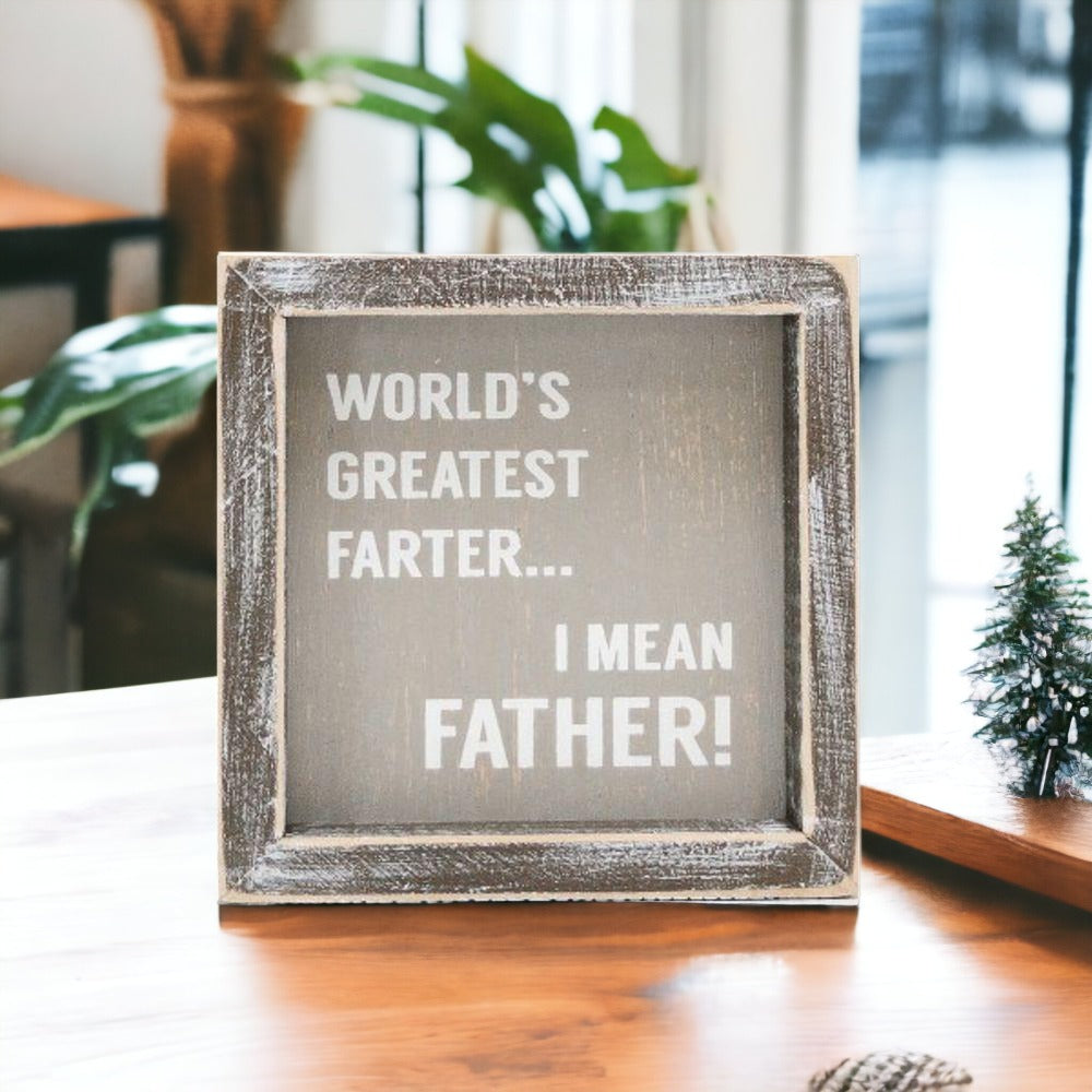 Handmade wooden sign reading 'World's Greatest Farter...I Mean Father' in distressed gray and white colors.