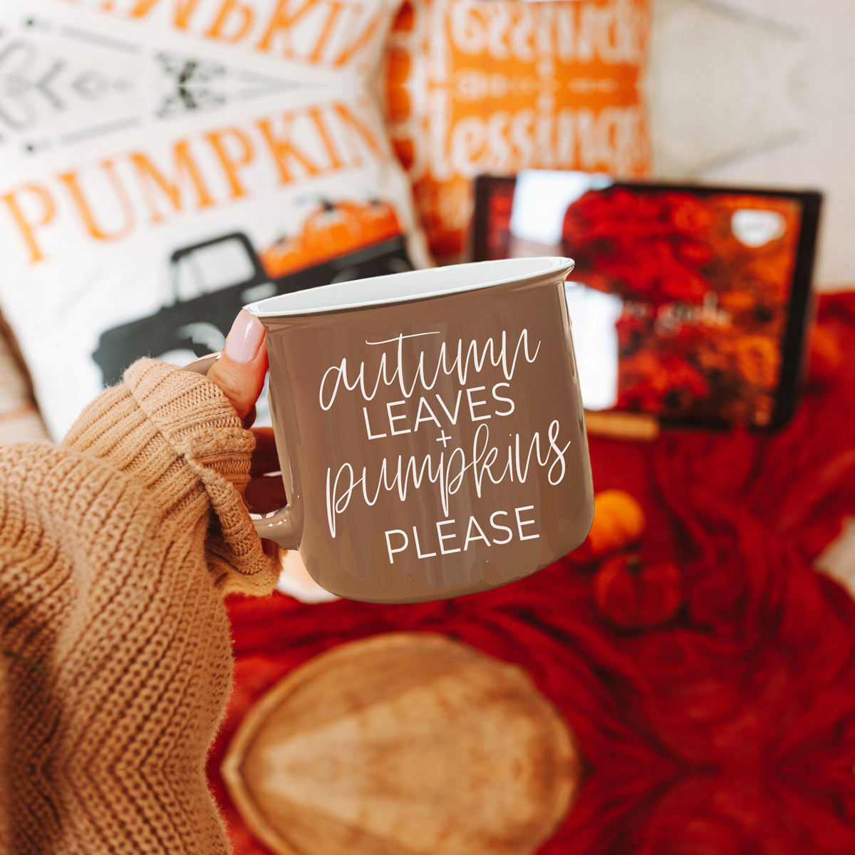 A ceramic campfire style mug featuring a neutral brown tone with white lettering that reads 'Autumn Leaves + Pumpkins Please', designed for fall.