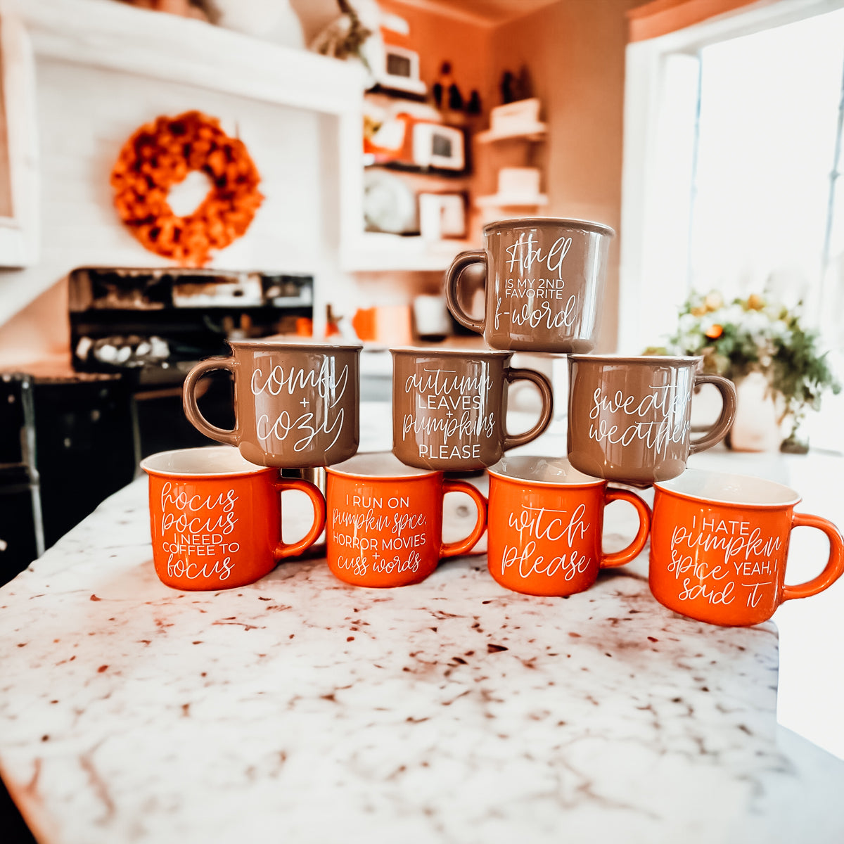 A ceramic campfire style mug featuring a neutral brown tone with white lettering that reads 'Autumn Leaves + Pumpkins Please', designed for fall.