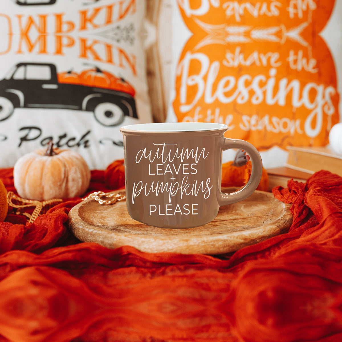 A ceramic campfire style mug featuring a neutral brown tone with white lettering that reads 'Autumn Leaves + Pumpkins Please', designed for fall.