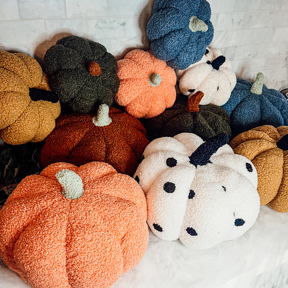 A plush Blair Pumpkin II in vibrant colors, showcasing its soft teddy velvet fabric and charming design, perfect for fall decor.