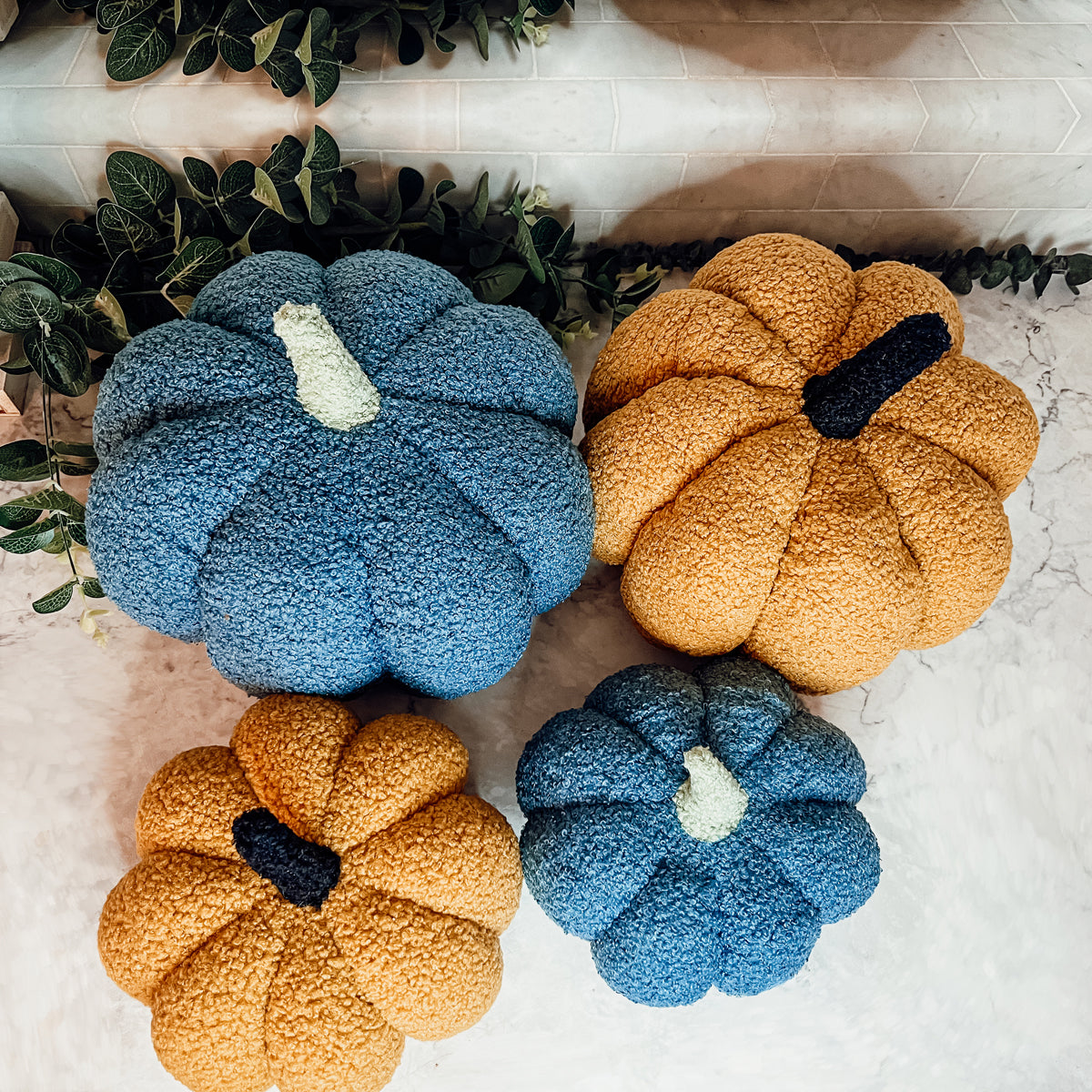 A plush Blair Pumpkin II in vibrant colors, showcasing its soft teddy velvet fabric and charming design, perfect for fall decor.