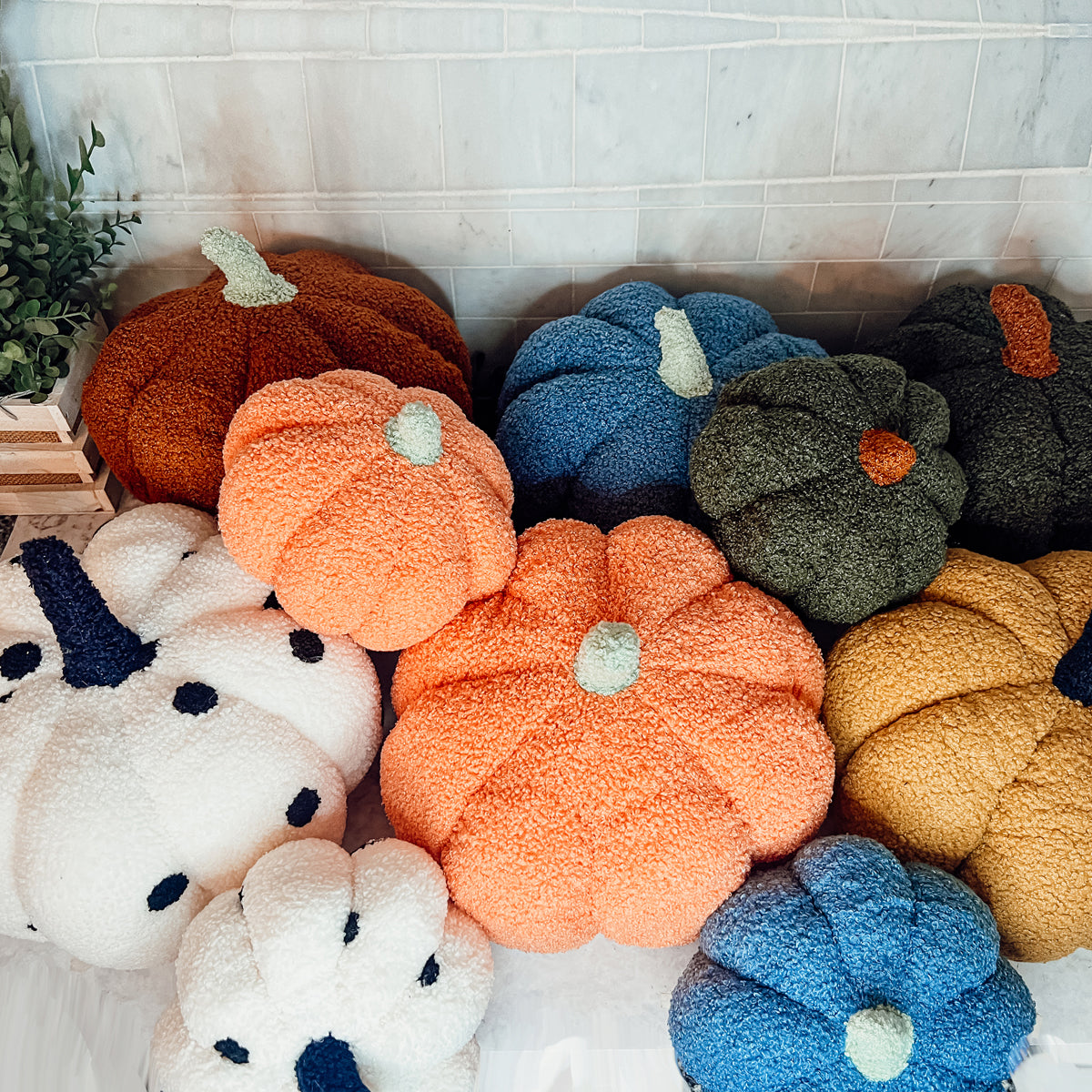 A plush Blair Pumpkin II in vibrant colors, showcasing its soft teddy velvet fabric and charming design, perfect for fall decor.