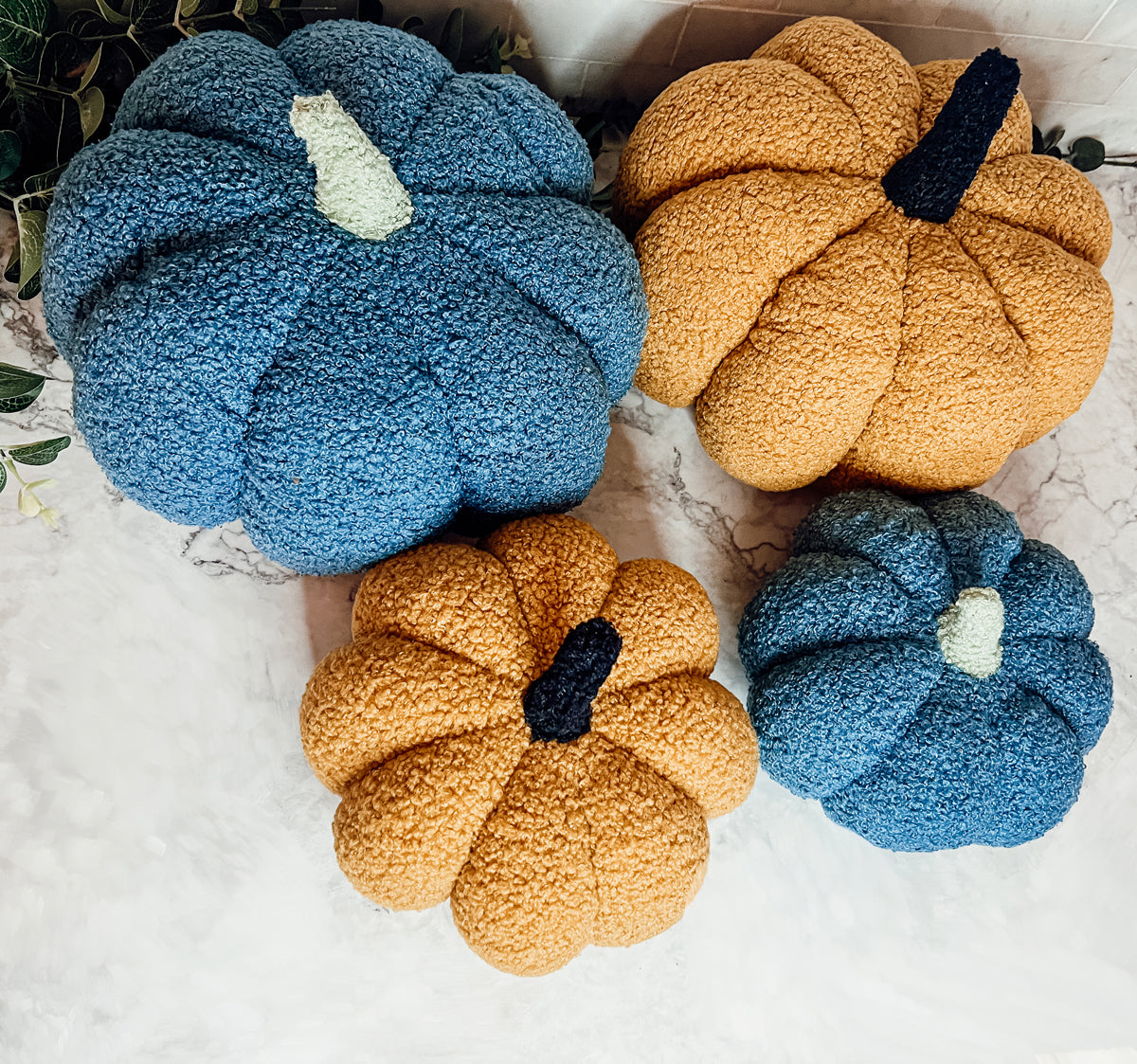 A plush Blair Pumpkin II in vibrant colors, showcasing its soft teddy velvet fabric and charming design, perfect for fall decor.