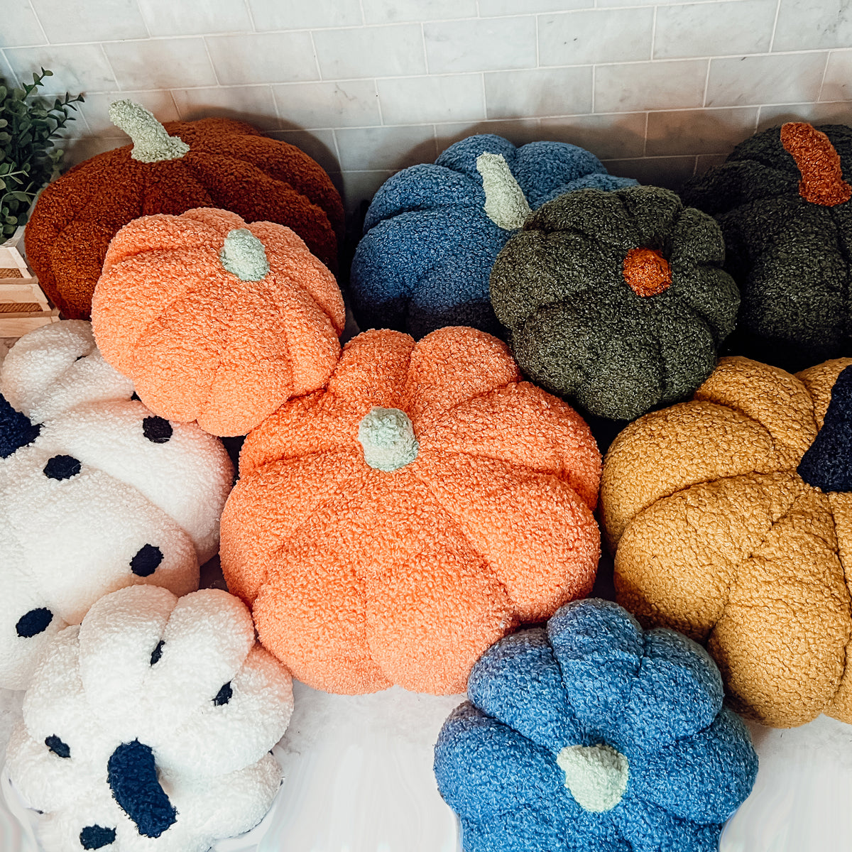 A plush Blair Pumpkin II in vibrant colors, showcasing its soft teddy velvet fabric and charming design, perfect for fall decor.