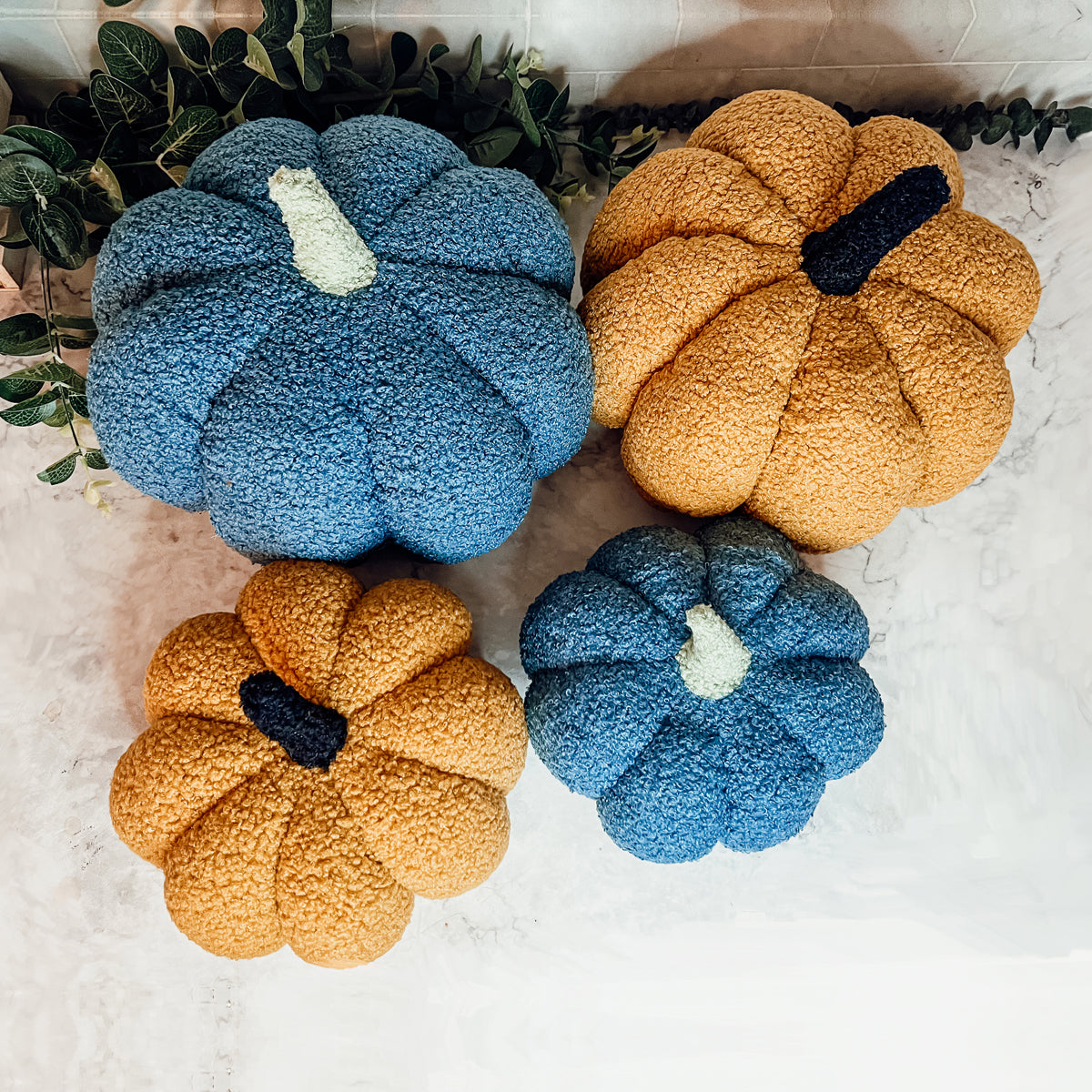 A plush Blair Pumpkin II in vibrant colors, showcasing its soft teddy velvet fabric and charming design, perfect for fall decor.