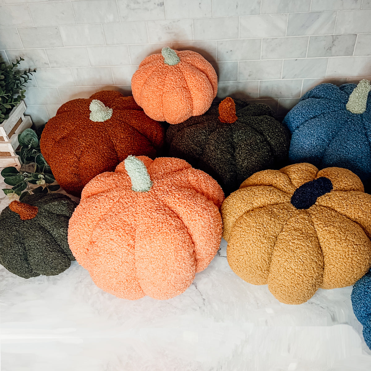 A plush Blair Pumpkin II in vibrant colors, showcasing its soft teddy velvet fabric and charming design, perfect for fall decor.