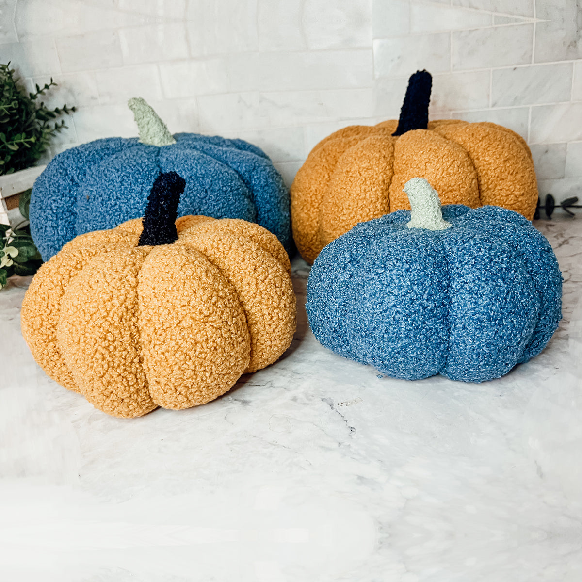 A plush Blair Pumpkin II in vibrant colors, showcasing its soft teddy velvet fabric and charming design, perfect for fall decor.