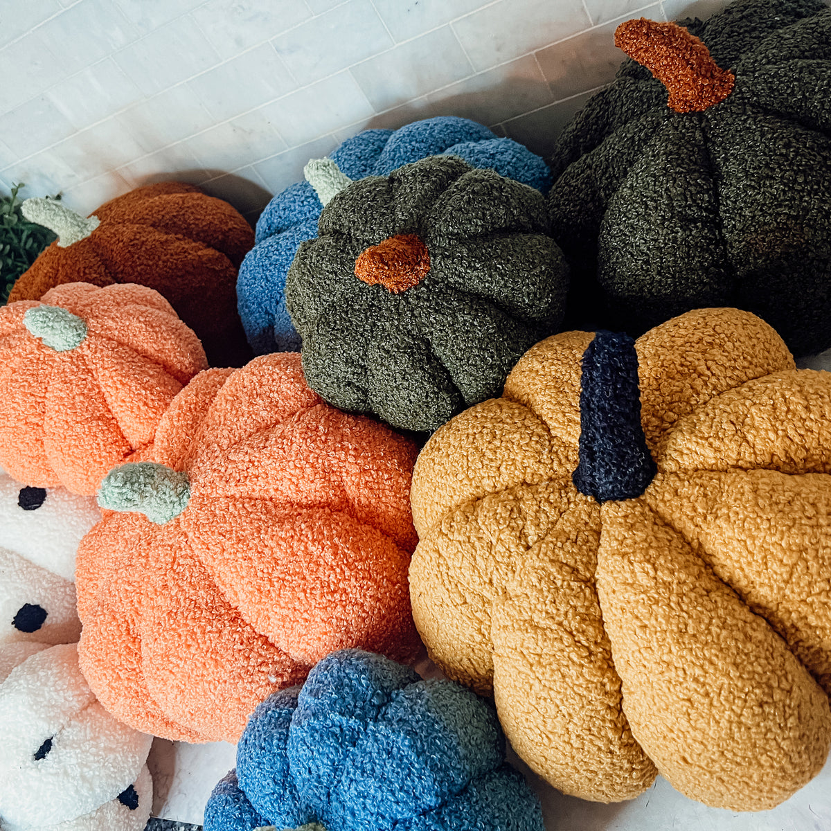 A plush Blair Pumpkin II in vibrant colors, showcasing its soft teddy velvet fabric and charming design, perfect for fall decor.