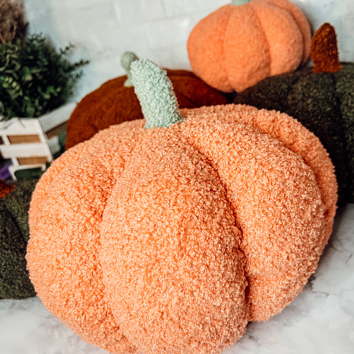 A plush Blair Pumpkin II in vibrant colors, showcasing its soft teddy velvet fabric and charming design, perfect for fall decor.