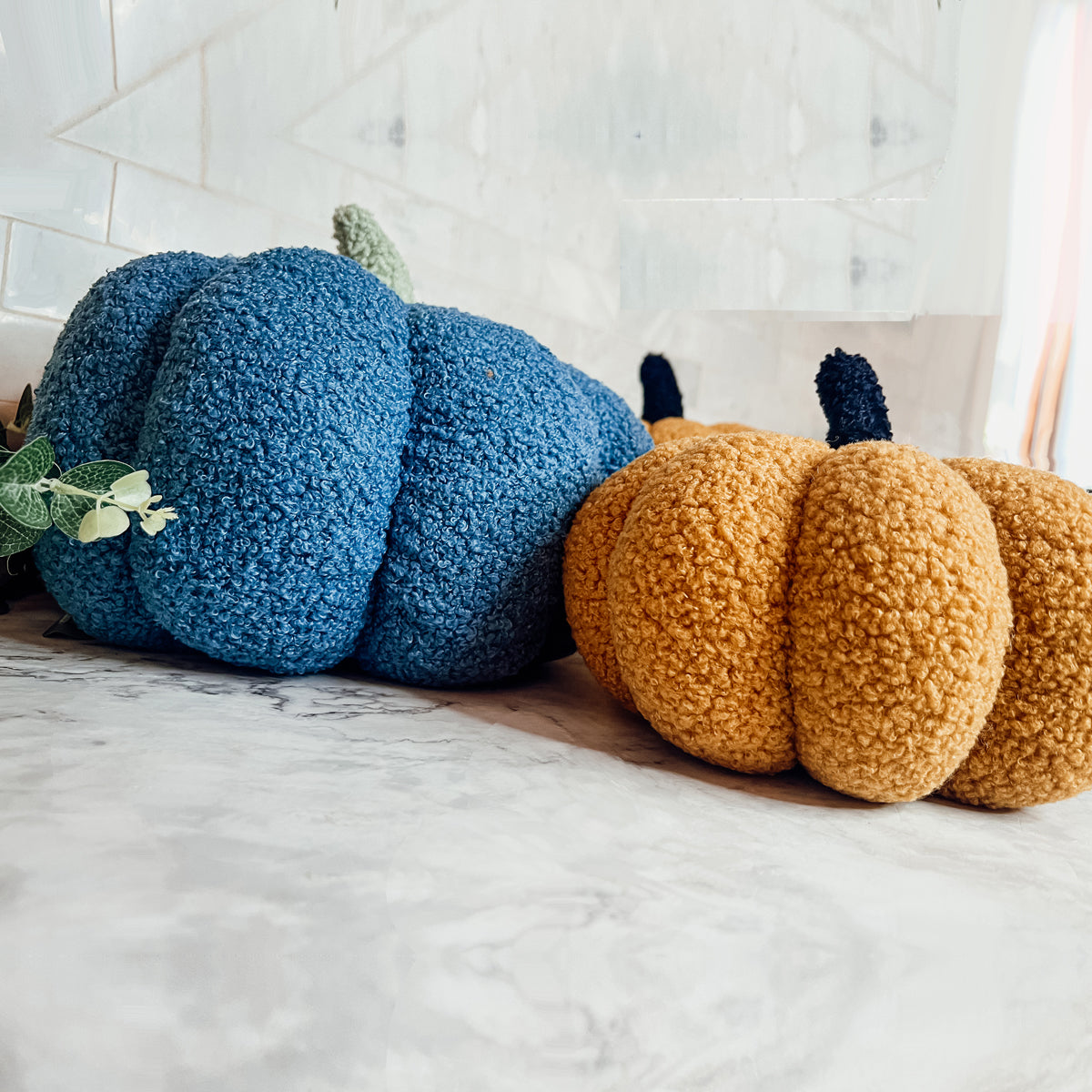 A plush Blair Pumpkin II in vibrant colors, showcasing its soft teddy velvet fabric and charming design, perfect for fall decor.