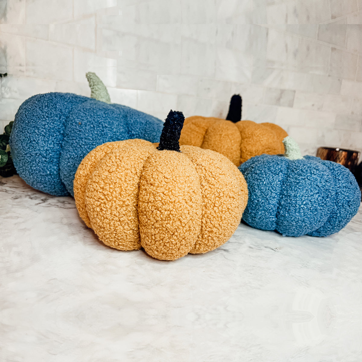 A plush Blair Pumpkin II in vibrant colors, showcasing its soft teddy velvet fabric and charming design, perfect for fall decor.