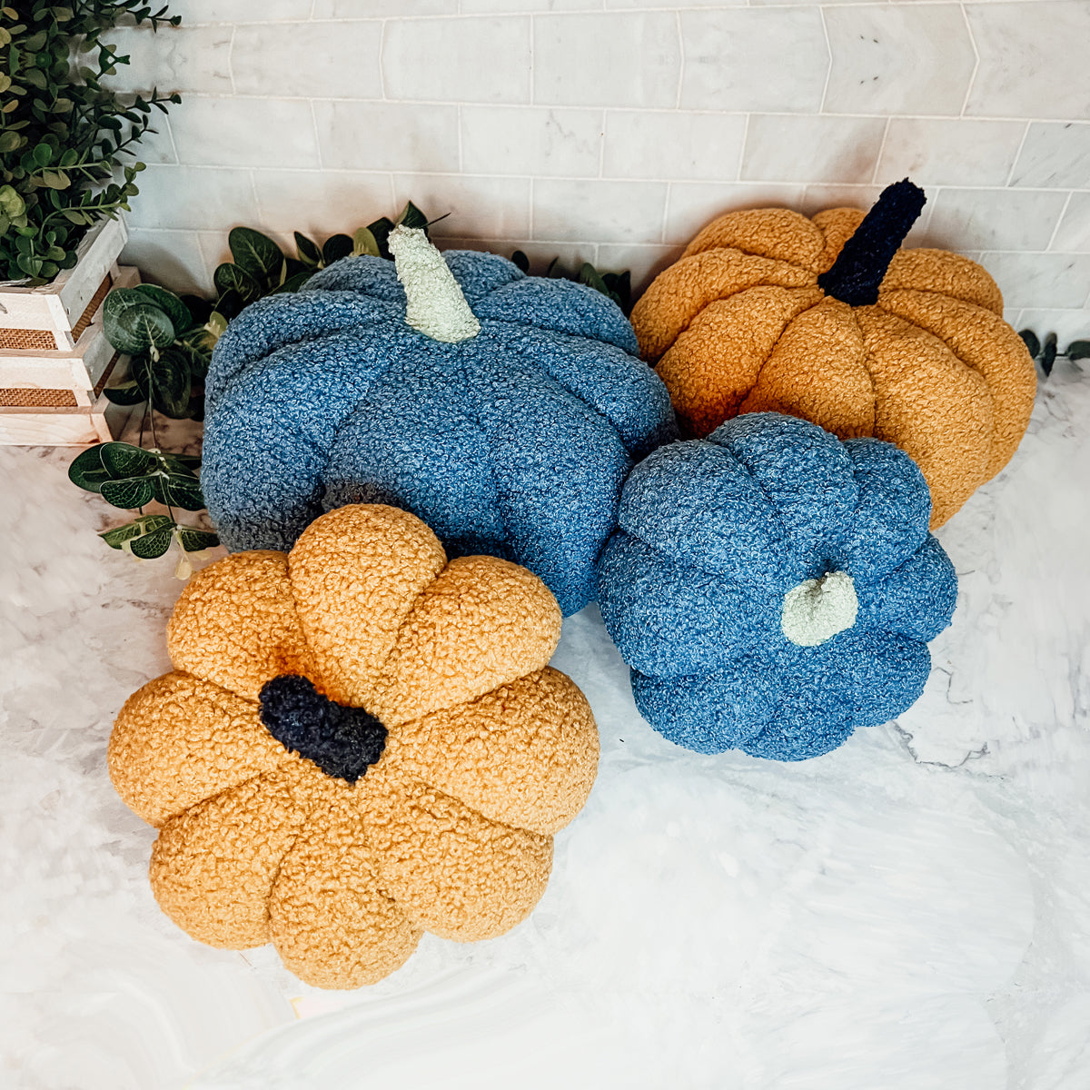 A plush Blair Pumpkin II in vibrant colors, showcasing its soft teddy velvet fabric and charming design, perfect for fall decor.