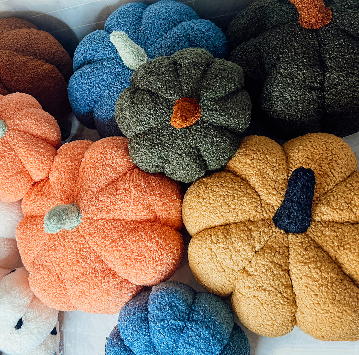 A plush Blair Pumpkin II in vibrant colors, showcasing its soft teddy velvet fabric and charming design, perfect for fall decor.