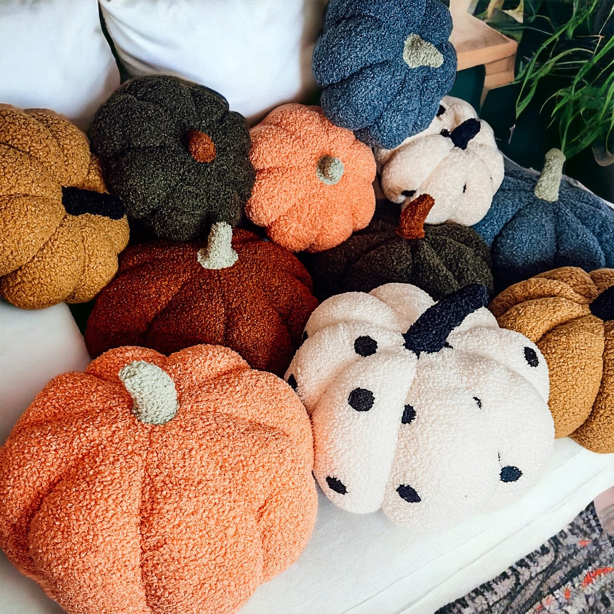 A plush Blair Pumpkin II in vibrant colors, showcasing its soft teddy velvet fabric and charming design, perfect for fall decor.