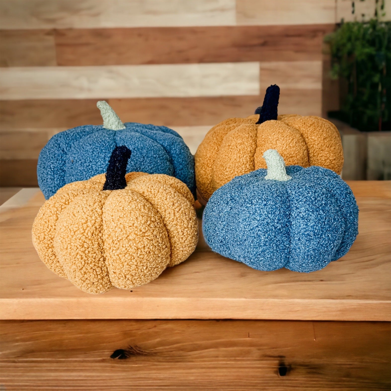 A plush Blair Pumpkin II in vibrant colors, showcasing its soft teddy velvet fabric and charming design, perfect for fall decor.